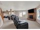 Open living room with cozy fireplace, plush seating, and seamless transition to other living areas at 1330 Redwood Dr, Greenfield, IN 46140