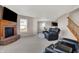 Living room with fireplace, comfy seating, and stairs to the upper level of the home at 1330 Redwood Dr, Greenfield, IN 46140