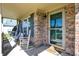 Inviting front porch with brick surround, swing, and welcome mat creating a cozy entrance at 1330 Redwood Dr, Greenfield, IN 46140