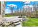 Large paver patio in backyard with stone steps and built in firepit, perfect for outdoor entertaining at 13314 Lansbury Ln, Fishers, IN 46037