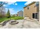 Paver patio with a built in stone firepit and seating area in the backyard of the home at 13314 Lansbury Ln, Fishers, IN 46037