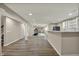 Finished basement with hardwood flooring, a modern kitchenette, and fitness equipment for exercise at 13314 Lansbury Ln, Fishers, IN 46037