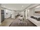 Finished basement with living area, bar, and seating area with wood floors at 13314 Lansbury Ln, Fishers, IN 46037