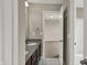 Stylish bathroom features a double vanity with granite countertops and white marble floors at 13314 Lansbury Ln, Fishers, IN 46037