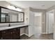 Bathroom featuring an expansive framed mirror, modern granite-topped vanity and tile flooring at 13314 Lansbury Ln, Fishers, IN 46037