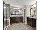Elegant bathroom with dual vanities, granite countertops, dark wood cabinets, and a tiled glass shower at 13314 Lansbury Ln, Fishers, IN 46037