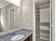 Bathroom featuring granite countertops, a mirror, and a closet at 13314 Lansbury Ln, Fishers, IN 46037