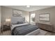 Well-lit bedroom with stylish decor, a comfortable bed, and a large window at 13314 Lansbury Ln, Fishers, IN 46037