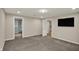 Carpeted bedroom with television and open doorway at 13314 Lansbury Ln, Fishers, IN 46037