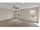 A neutral bedroom with carpet, dual windows, and a ceiling fan at 13314 Lansbury Ln, Fishers, IN 46037