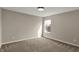 Spacious bedroom with plush carpeting and a window offering natural light at 13314 Lansbury Ln, Fishers, IN 46037