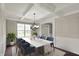 Bright dining room with coffered ceilings, wainscoting, and view to front yard at 13314 Lansbury Ln, Fishers, IN 46037