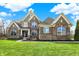 A beautiful two-story brick home with a well-manicured lawn, professional landscaping, and great curb appeal at 13314 Lansbury Ln, Fishers, IN 46037