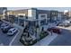 Exterior view of a restaurant with outdoor patio seating, modern design, and ample parking at 13314 Lansbury Ln, Fishers, IN 46037
