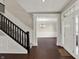 Bright foyer with hardwood floors, staircase with black railing, and elegant chandelier at 13314 Lansbury Ln, Fishers, IN 46037