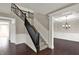 Bright foyer with hardwood floors, a staircase with black railing, and elegant dining room is visible at 13314 Lansbury Ln, Fishers, IN 46037