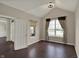 Bright home office with a large arched window and hardwood floors at 13314 Lansbury Ln, Fishers, IN 46037
