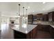 Open floorplan kitchen with stainless appliances and a center island at 13314 Lansbury Ln, Fishers, IN 46037