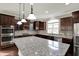 Kitchen with granite countertops, stainless appliances, and modern lighting at 13314 Lansbury Ln, Fishers, IN 46037