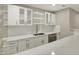 This kitchenette features sleek white cabinets, modern countertops, and stainless steel appliances at 13314 Lansbury Ln, Fishers, IN 46037