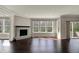 Open living room features a stone fireplace, hardwood floors, and an access to the outside patio at 13314 Lansbury Ln, Fishers, IN 46037