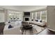 Spacious living room featuring fireplace, large windows and comfortable seating arrangements at 13314 Lansbury Ln, Fishers, IN 46037