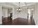 Spacious living room with dark hardwood floors and a stylish chandelier at 13314 Lansbury Ln, Fishers, IN 46037