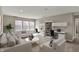 Comfortable living room with office space featuring multiple seating options and built-in shelving at 13314 Lansbury Ln, Fishers, IN 46037
