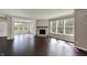 Living room features large windows, stone fireplace, and an open layout to the sunroom at 13314 Lansbury Ln, Fishers, IN 46037