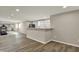 Spacious living room features a kitchenette bar, hardwood floors, and plenty of room to entertain at 13314 Lansbury Ln, Fishers, IN 46037