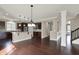 Spacious open floorplan with kitchen, hardwood floors, and staircase at 13314 Lansbury Ln, Fishers, IN 46037