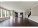 Spacious living room featuring hardwood floors, with an open view to the kitchen and staircase at 13314 Lansbury Ln, Fishers, IN 46037