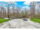 Outdoor patio with fire pit overlooking the green backyard and wooded area at 13314 Lansbury Ln, Fishers, IN 46037