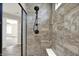 Luxurious tiled shower with a built-in bench, a hand shower, and modern fixtures at 13314 Lansbury Ln, Fishers, IN 46037