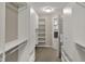 Spacious walk-in closet featuring custom shelving, ample storage and convenient access to the Primary bathroom at 13314 Lansbury Ln, Fishers, IN 46037