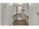 Functional walk-in closet with carpet floors, custom shelves, and closet rods for efficient storage solutions at 13314 Lansbury Ln, Fishers, IN 46037