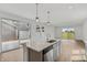 Modern kitchen featuring an island, dishwasher, sliding glass door, and outdoor views at 13418 Vickery Ridge Dr, Fishers, IN 46037