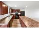 Modern kitchen features stainless steel appliances and wooden cabinets, spacious and bright at 13813 N Hawkers Hill Dr, Camby, IN 46113