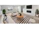 Bright living room featuring a decorative fireplace, sleek furniture, and a modern striped rug at 13813 N Hawkers Hill Dr, Camby, IN 46113