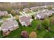 Beautiful aerial view of homes in a neighborhood featuring lush green lawns and mature trees at 13933 Wildcat Dr, Carmel, IN 46033