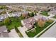 Aerial perspective of an attractive residence surrounded by manicured lawns and mature trees in a residential area at 13933 Wildcat Dr, Carmel, IN 46033