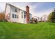 Lush backyard showcasing a well-kept lawn, mature trees and a deck with steps, for easy outdoor enjoyment at 13933 Wildcat Dr, Carmel, IN 46033