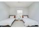 Bright bedroom with two beds, a ceiling fan, and a window at 13933 Wildcat Dr, Carmel, IN 46033