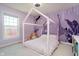 Whimsical bedroom with unique purple mural and a cozy house frame bed at 13933 Wildcat Dr, Carmel, IN 46033