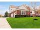 View of side of home with brick and siding, manicured lawn, and two car garage at 13933 Wildcat Dr, Carmel, IN 46033