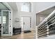 Bright foyer featuring a high ceiling, large windows, and modern staircase at 13933 Wildcat Dr, Carmel, IN 46033