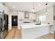 Bright kitchen featuring white cabinets, a kitchen island, stainless steel appliances, and stylish pendant lighting at 13933 Wildcat Dr, Carmel, IN 46033