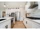 Updated eat-in kitchen with stainless steel appliances, white cabinets, marble backsplash, and kitchen island at 13933 Wildcat Dr, Carmel, IN 46033