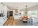 Modern eat-in kitchen with stainless steel appliances, white cabinets, and sliding glass door to the backyard at 13933 Wildcat Dr, Carmel, IN 46033