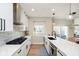 Well-lit kitchen featuring stainless steel appliances, a kitchen island, white cabinets, and marble backsplash at 13933 Wildcat Dr, Carmel, IN 46033
